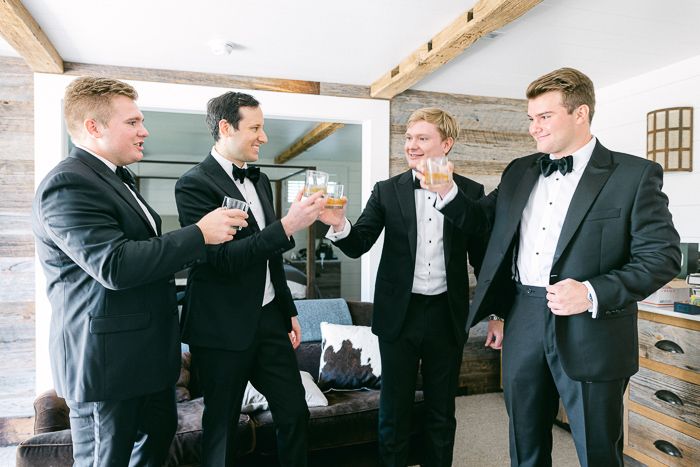 Groom and groomsmen have a drink before the wedding ceremony