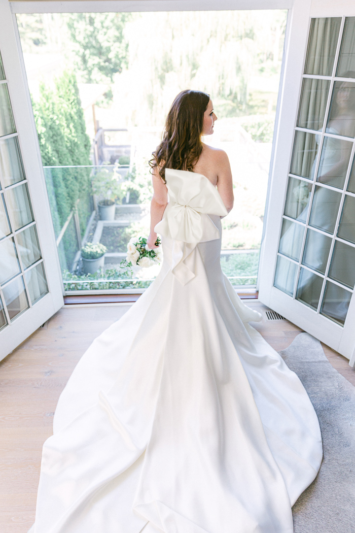 Bride looks outside before Connecticut micro wedding