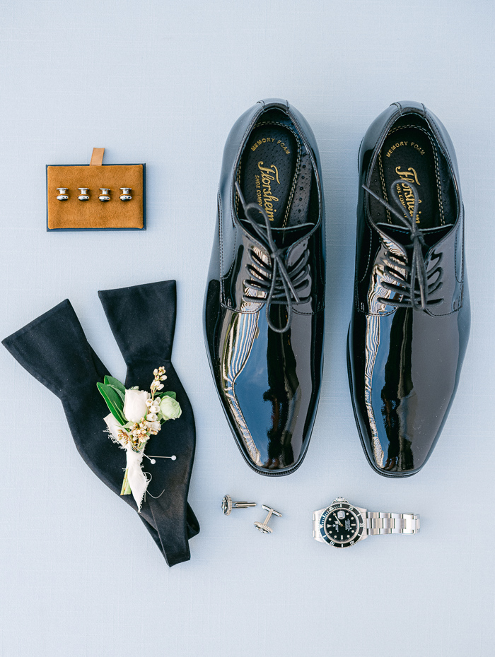 Groom wedding details with shoes, bow tie, cuff links and watch