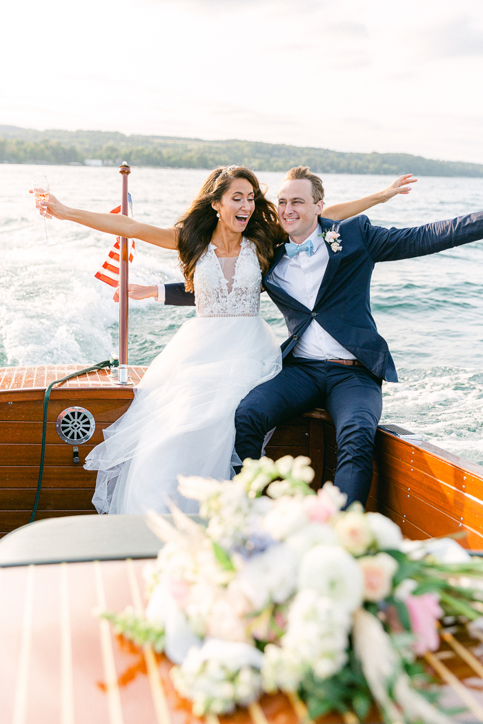 Bride and groom photos on Skaneateles Lake with a vintage boat rental
