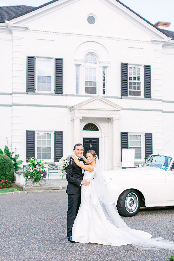 Bride and Groom Stand in Front on Rolls Royce and Nissequogue Golf Club