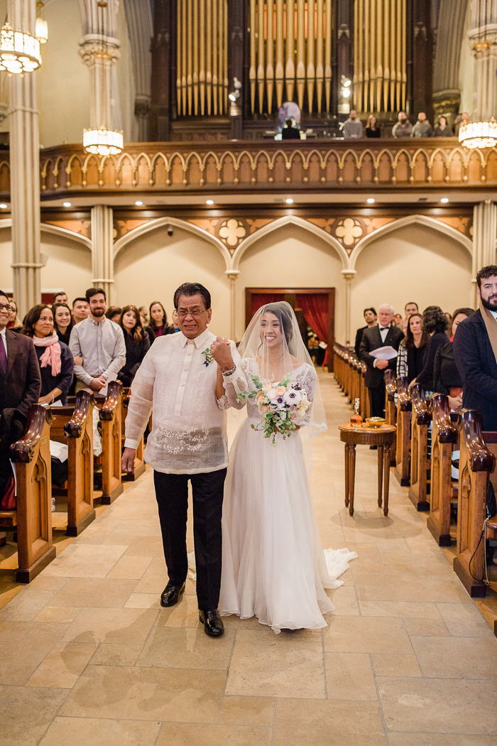 bride walking down the aisle at Catholic church in  NYC