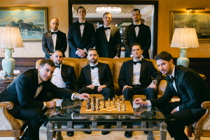 groom getting ready photos playing chess with groomsmen