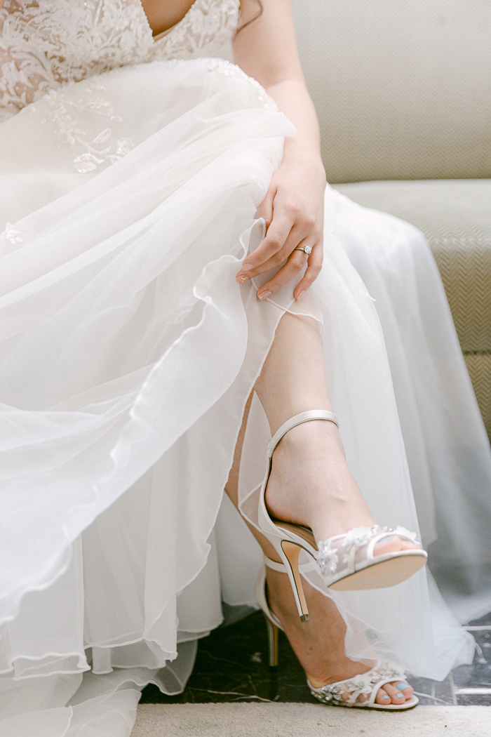 Bride looking at her wedding shoes