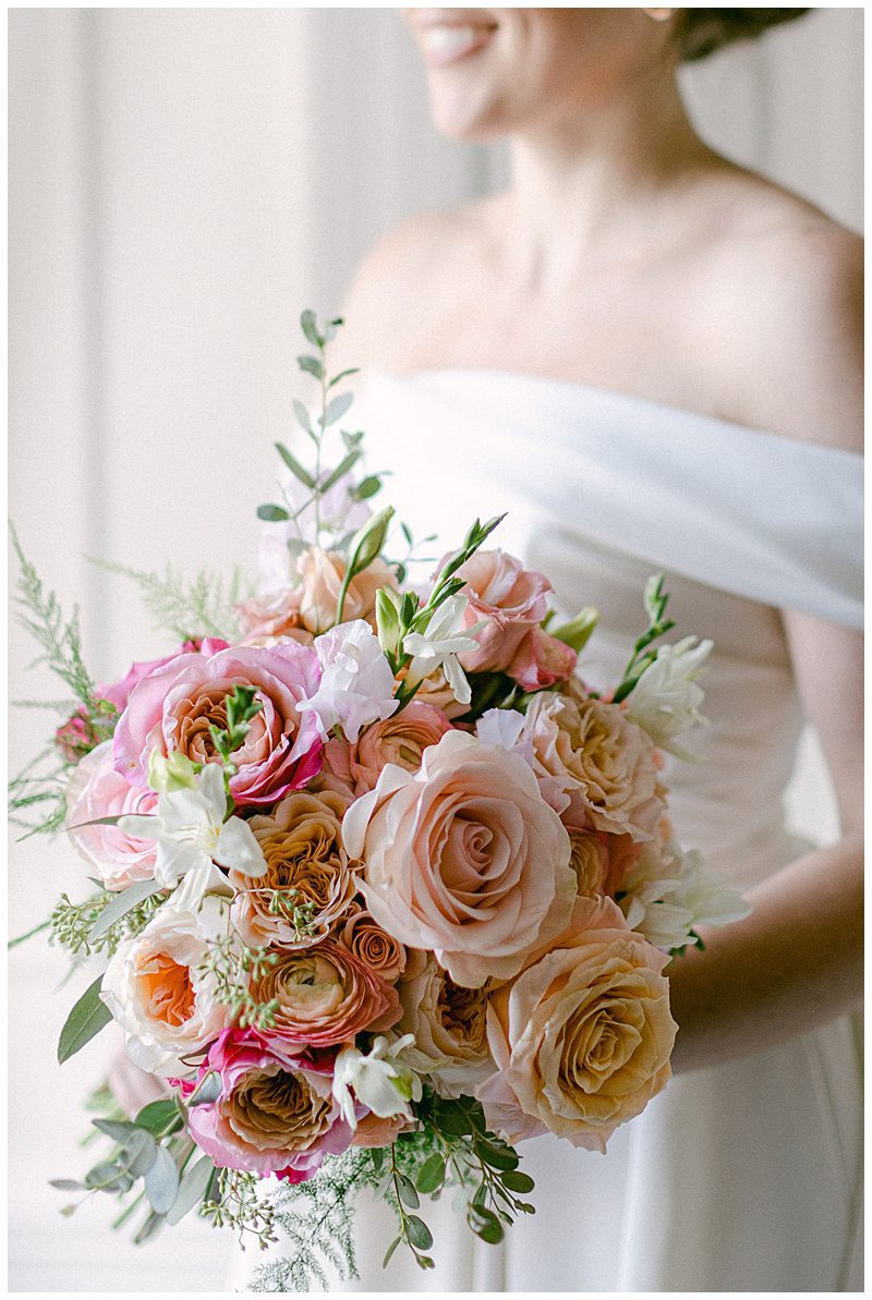CLOSE UP OF PINK AND PEACH BRIDAL BOUQUET
