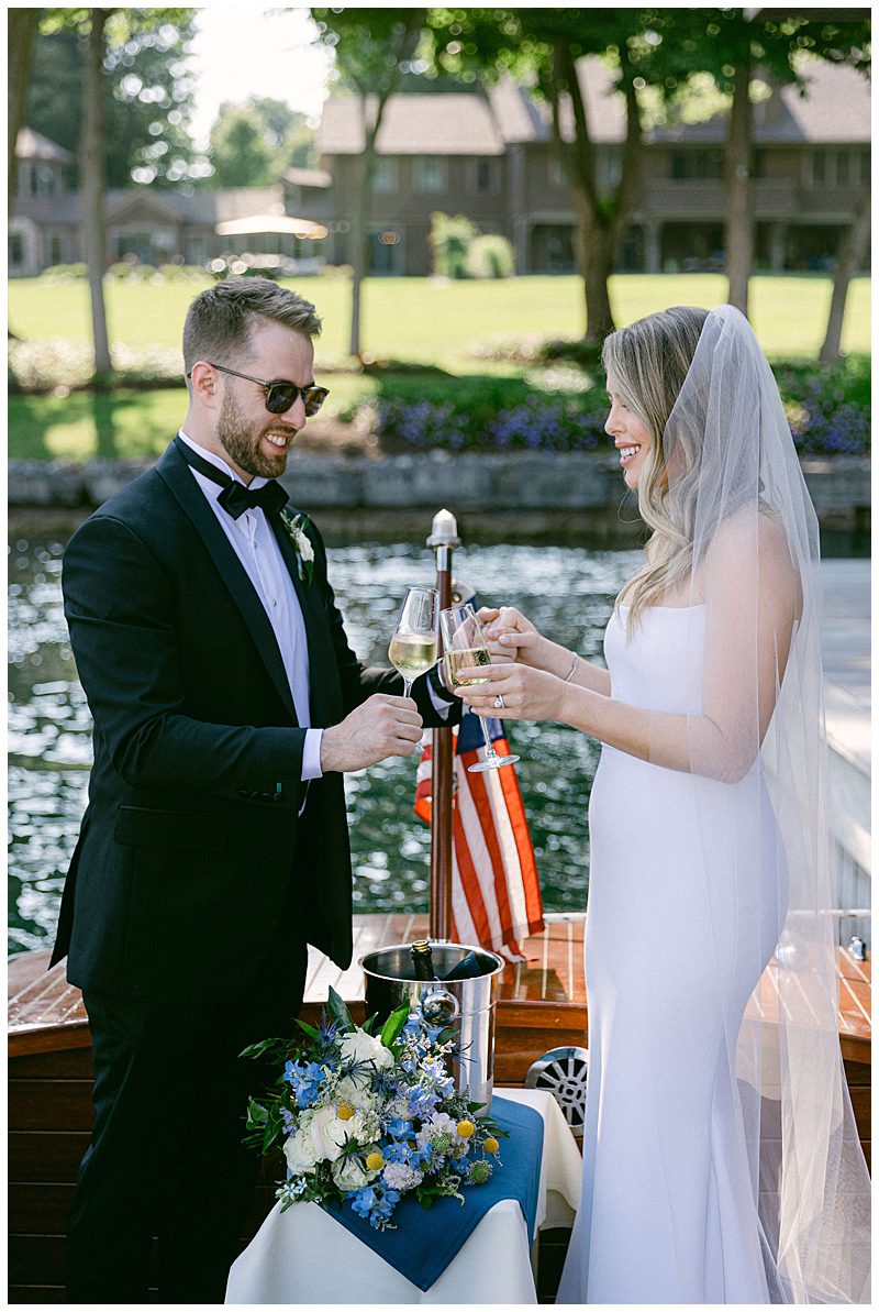 BRIDE AND GROOM WITH CHAMPAGNE ON BOAT LEAVING CEREMONY 