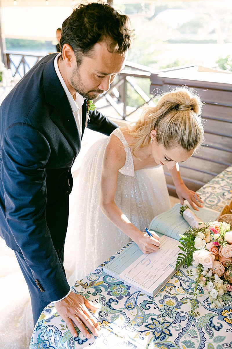 BRIDE SIGNING THE MARRIAGE CERTIFICATE