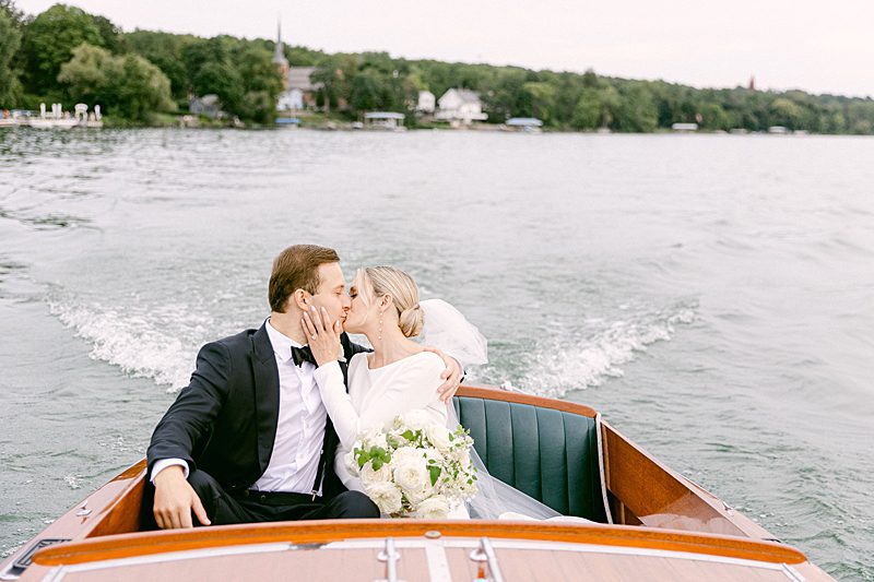 BRIDE AND GROOM LEAVING CEREMONY BY BOAT AT INNS OF AURORA