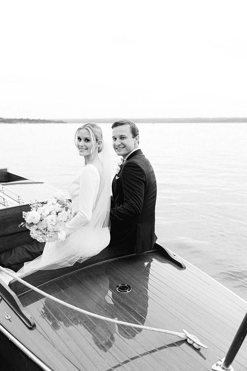 BRIDE AND GROOM LEAVING CEREMONY BY BOAT AT INNS OF AURORA