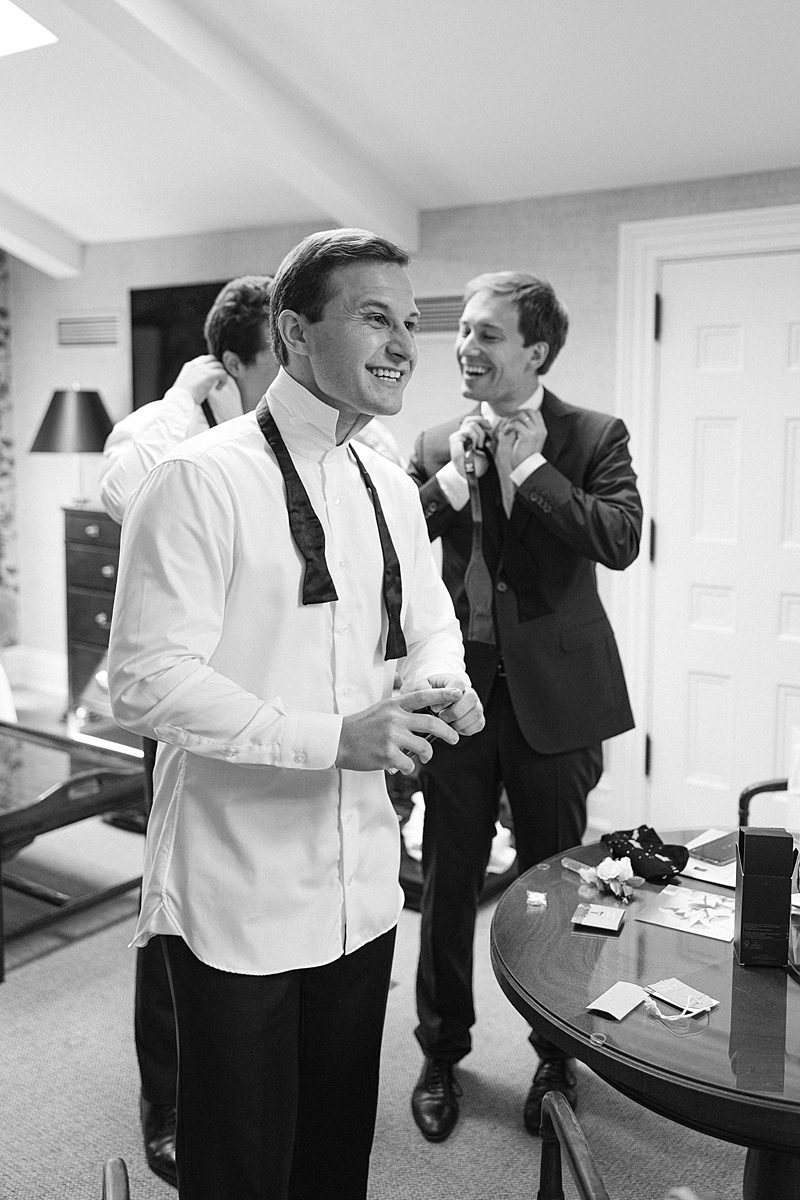 BLACK AND WHITE PHOTO OF GROOM GETTING READY