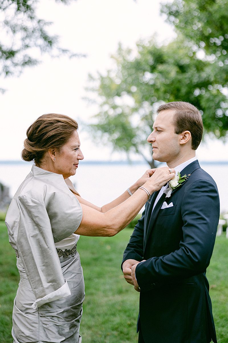 GROOMS MOTHER HELPING HIM WITH BOW TIE